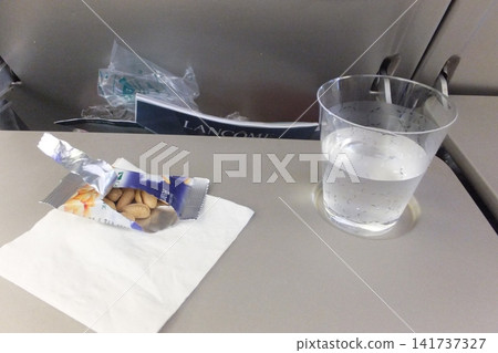 Snacks and water on the airplane Snacks and water on the airplane 141737327