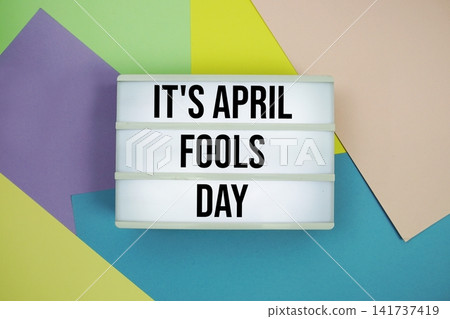 It's April Fools' Day text in lightbox flat lay on colorful pastel background It's April Fools' Day text in lightbox flat lay on colorful pastel background 141737419