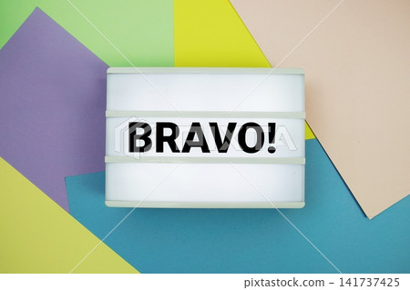 Bravo! text in lightbox flat lay on colorful pastel background Bravo! text in lightbox flat lay on colorful pastel background 141737425