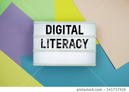 Digital Literacy text in lightbox flat lay on colorful pastel background Digital Literacy text in lightbox flat lay on colorful pastel background 141737426