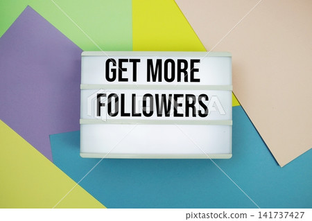 Get More Followers text in lightbox flat lay on colorful pastel background Get More Followers text in lightbox flat lay on colorful pastel background 141737427