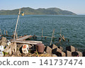 A boat floating on a lake 141737474