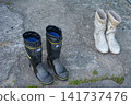 Rubber boots left on the beach 141737476