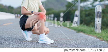 Young adult female runner with knee pain from ACL injury or patellofemoral syndrome. woman having joint ache, ligament tear or patellar tendinitis during running. Sports medical and healthcare concept Young adult female runner with knee pain from ACL injury or patellofemoral syndrome. woman having joint ache, ligament tear or patellar tendinitis during running. Sports medical and healthcare concept 141737833