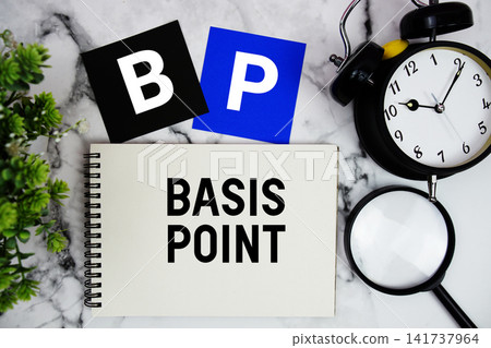 BP Basis Point text written on notepad with alarm clock and magnifying glass on marble background BP Basis Point text written on notepad with alarm clock and magnifying glass on marble background 141737964