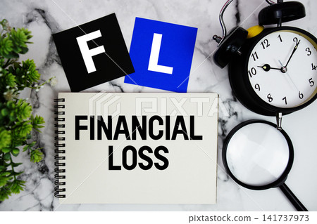 FL Financial Loss text written on notepad with alarm clock and magnifying glass on marble background FL Financial Loss text written on notepad with alarm clock and magnifying glass on marble background 141737973