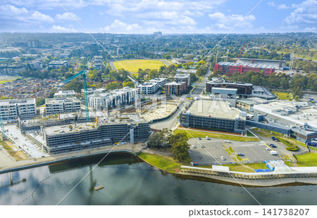 Aerial view of a residential construction site and surrounding buildings Aerial view of a residential construction site and surrounding buildings 141738207