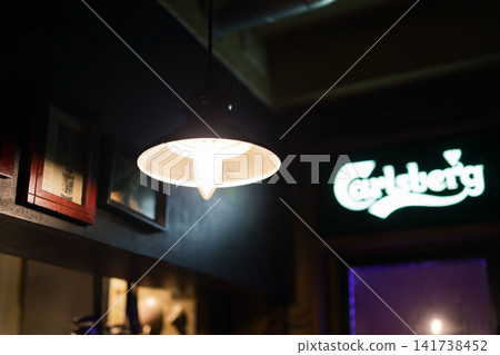 Lights shining in a dimly lit bar Lights shining in a dimly lit bar 141738452