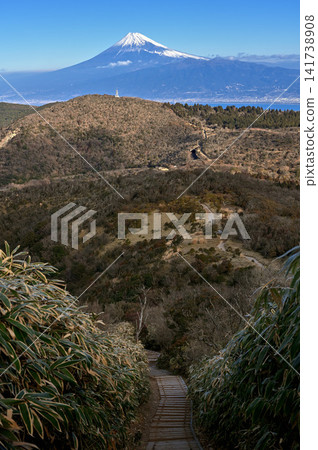 Mount Fuji towering beyond the bamboo grass-covered ridge trail of Mt. Kodaruma on the Izu Peninsula. Mount Fuji towering beyond the bamboo grass-covered ridge trail of Mt. Kodaruma on the Izu Peninsula. 141738908