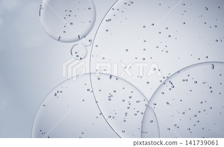 Blue water gel drops texture 3d background, cosmetic liquid circle pattern with bubbles. Face cleanser, hyaluronic acid serum, aqua collagen jelly cream, skin care moisture body wash. 3D illustration Blue water gel drops texture 3d background, cosmetic liquid circle pattern with bubbles. Face cleanser, hyaluronic acid serum, aqua collagen jelly cream, skin care moisture body wash. 3D illustration 141739061