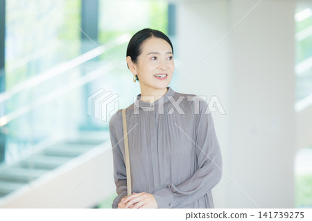 一位中年婦女在大廳行走 一位中年婦女在大廳行走 141739275