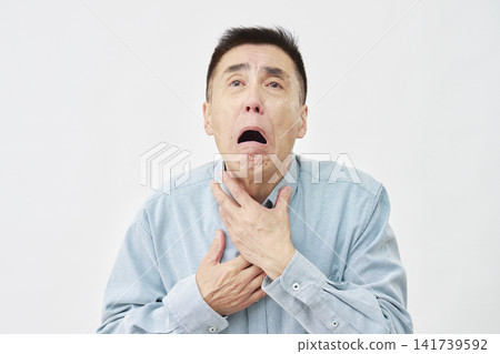 A man choking on a white background A man choking on a white background 141739592