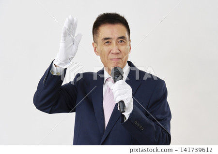 Male candidate giving a speech against a white background 141739612