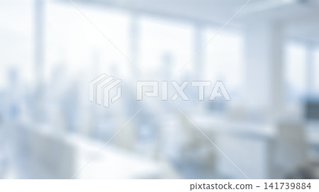 Blurred background showing empty open plan corporate office interior featuring white desks beside large windows revealing bright sunlight illuminating commercial business workspace Blurred background showing empty open plan corporate office interior featuring white desks beside large windows revealing bright sunlight illuminating commercial business workspace 141739884