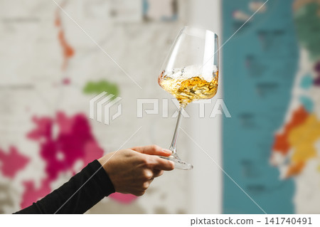 Close-Up of Wine Tasting Experience With Swirling Glass Against Map Background 141740491