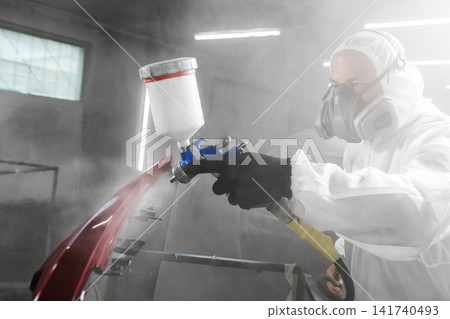 Car paint job by professional worker, car painting procedure in car service, body paint garage. Car paint job by professional worker, car painting procedure in car service, body paint garage. 141740493