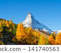 Passenger train on a railway in Switzerland. Autumn nature in the Alps. Passenger train on a railway in Switzerland. Autumn nature in the Alps. 141740563