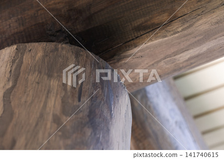Close-up of a rustic wooden log beam and timber post Close-up of a rustic wooden log beam and timber post 141740615