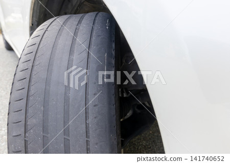 The tire is worn down and the internal carcass is exposed. The tire is worn down and the internal carcass is exposed. 141740652