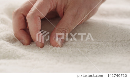 closeup shot of man touching white cotton terry towel closeup shot of man touching white cotton terry towel 141740710