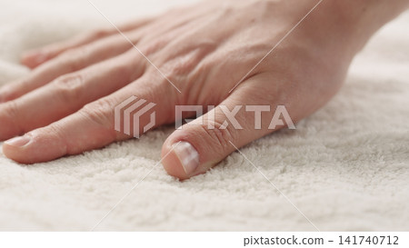closeup shot of man touching white cotton terry towel closeup shot of man touching white cotton terry towel 141740712