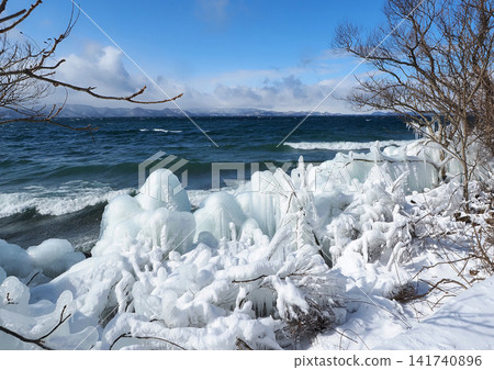 A winter phenomenon that is a highlight of Lake Inawashiro is the formation of ice formations resembling spray. The contrast between the white ice clinging to the trees and the green of the lake water is striking and beautiful. A winter phenomenon that is a highlight of Lake Inawashiro is the formation of ice formations resembling spray. The contrast between the white ice clinging to the trees and the green of the lake water is striking and beautiful. 141740896