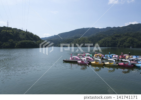 A boat floating on a lake A boat floating on a lake 141741171