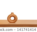 A modern-style terracotta vase sits on a wooden table. 141741414
