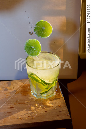 Slice of Lime Dropping Into a Cold Beverage Slice of Lime Dropping Into a Cold Beverage 141741591