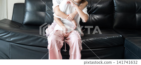 Playful sisters relaxing at home share a cheerful hug on the living room sofa, capturing joyful childhood moments, fun interaction, and everyday family lifestyle. Playful sisters relaxing at home share a cheerful hug on the living room sofa, capturing joyful childhood moments, fun interaction, and everyday family lifestyle. 141741632