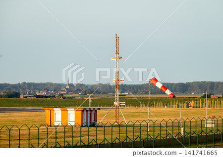 Approach Lights and Windsock Along the Runway Approach Lights and Windsock Along the Runway 141741665