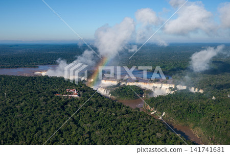 A magnificent panoramic view of Iguazu Falls, overlooking a valley surrounded by forest. A magnificent panoramic view of Iguazu Falls, overlooking a valley surrounded by forest. 141741681