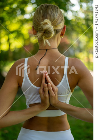 Woman in Reverse Prayer Hands Yoga Pose From Behind Woman in Reverse Prayer Hands Yoga Pose From Behind 141741843