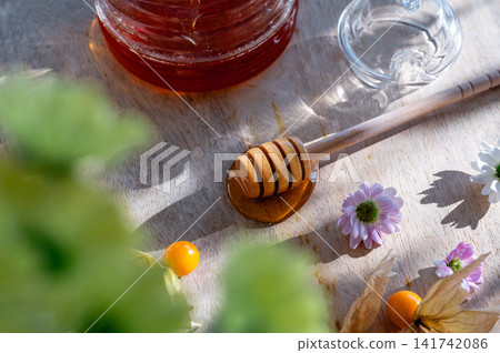 Glass Honey Jar with a Bee Lid and Dipper Detail Glass Honey Jar with a Bee Lid and Dipper Detail 141742086