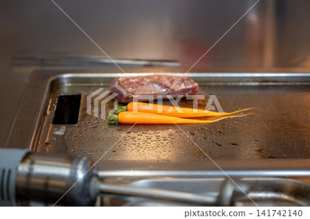 Chef Cooking Meat and Carrots Close-Up Chef Cooking Meat and Carrots Close-Up 141742140