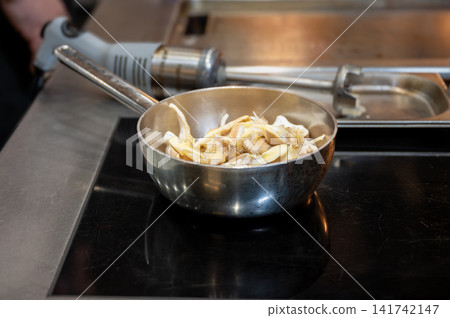 Chef Cooking Mushrooms in Restaurant Kitchen Chef Cooking Mushrooms in Restaurant Kitchen 141742147