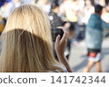 Young woman taking a photo 141742344