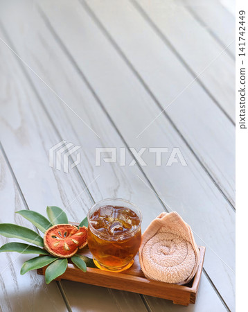 Bael fruit juice serving with cold towel Bael fruit juice serving with cold towel 141742449