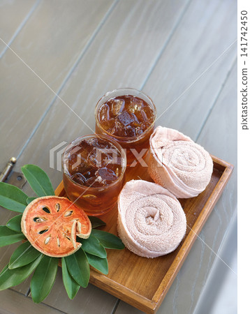 Bael fruit juice serving with cold towel Bael fruit juice serving with cold towel 141742450