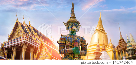 Colorful giant guardian statue with iconic temples and Grand Palace in Bangkok, Thailand. 141742464