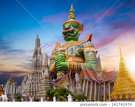 Colorful giant guardian statue with iconic temples and Grand Palace in Bangkok, Thailand. Colorful giant guardian statue with iconic temples and Grand Palace in Bangkok, Thailand. 141742474