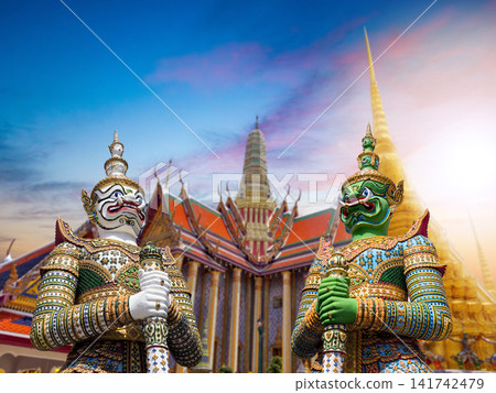 Colorful giant guardian statues with iconic temples and Grand Palace in Bangkok, Thailand. Colorful giant guardian statues with iconic temples and Grand Palace in Bangkok, Thailand. 141742479