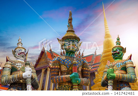 Colorful giant guardian statues with iconic temples and Grand Palace in Bangkok, Thailand. 141742481