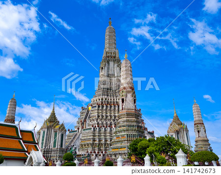 Wat Arun, the Temple of Dawn, under a bright blue sky in Bangkok, Thailand. Wat Arun, the Temple of Dawn, under a bright blue sky in Bangkok, Thailand. 141742673
