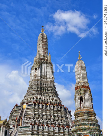 Wat Arun, the Temple of Dawn, under a bright blue sky in Bangkok, Thailand. 141742683
