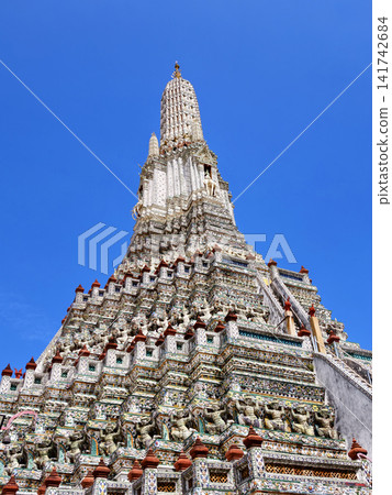 Wat Arun, the Temple of Dawn, under a bright blue sky in Bangkok, Thailand. Wat Arun, the Temple of Dawn, under a bright blue sky in Bangkok, Thailand. 141742684