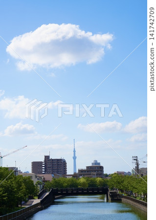 The Tokyo Skytree and a clear sky as seen from a bridge over a river. The Tokyo Skytree and a clear sky as seen from a bridge over a river. 141742709