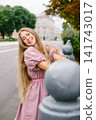 Happy Woman Leaning On City Railing 141743017
