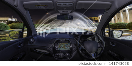 View from car interior of a fountain and modern building View from car interior of a fountain and modern building 141743038