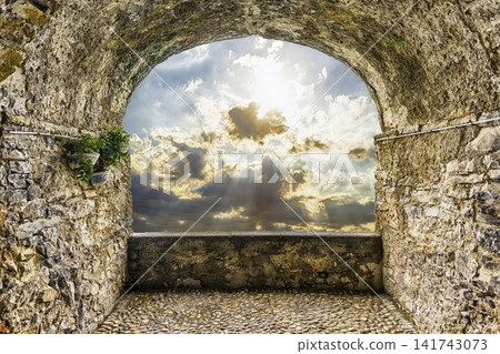 Ancient Stone Archway View to Dramatic Sunset Sky Ancient Stone Archway View to Dramatic Sunset Sky 141743073